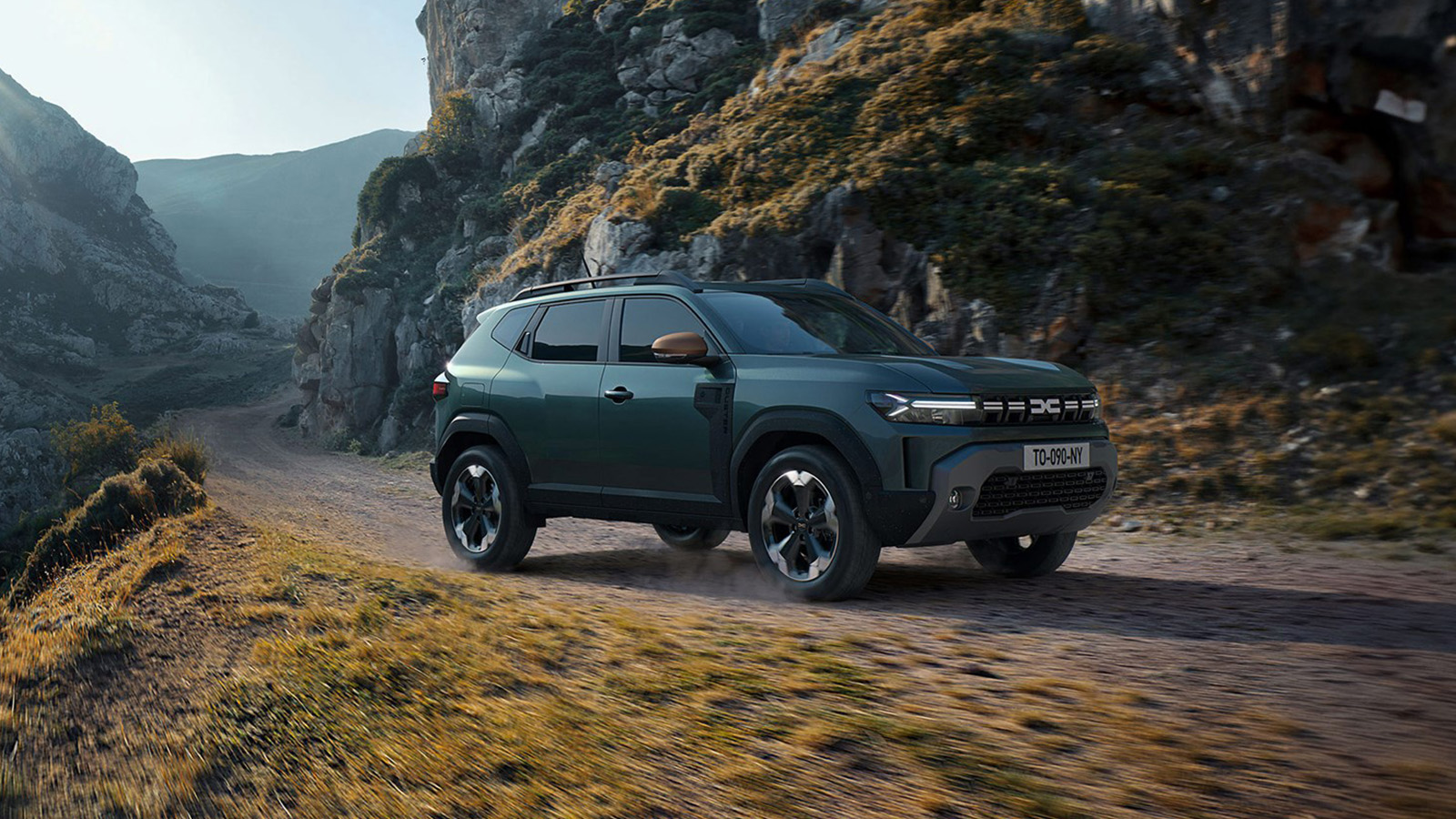 an orange dacia duster on the road