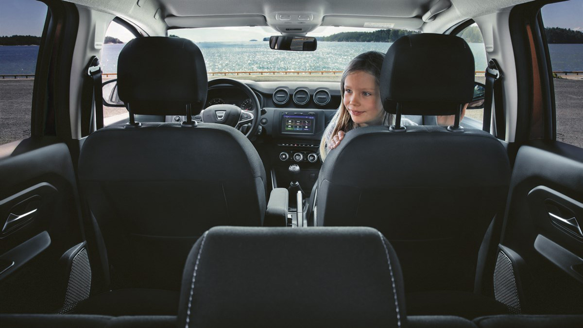 a kid in a dacia car