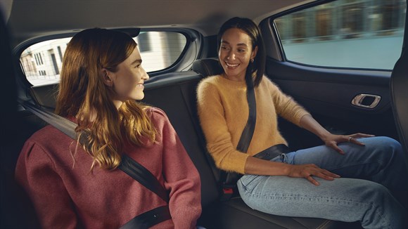 two girls sitting in the backsits